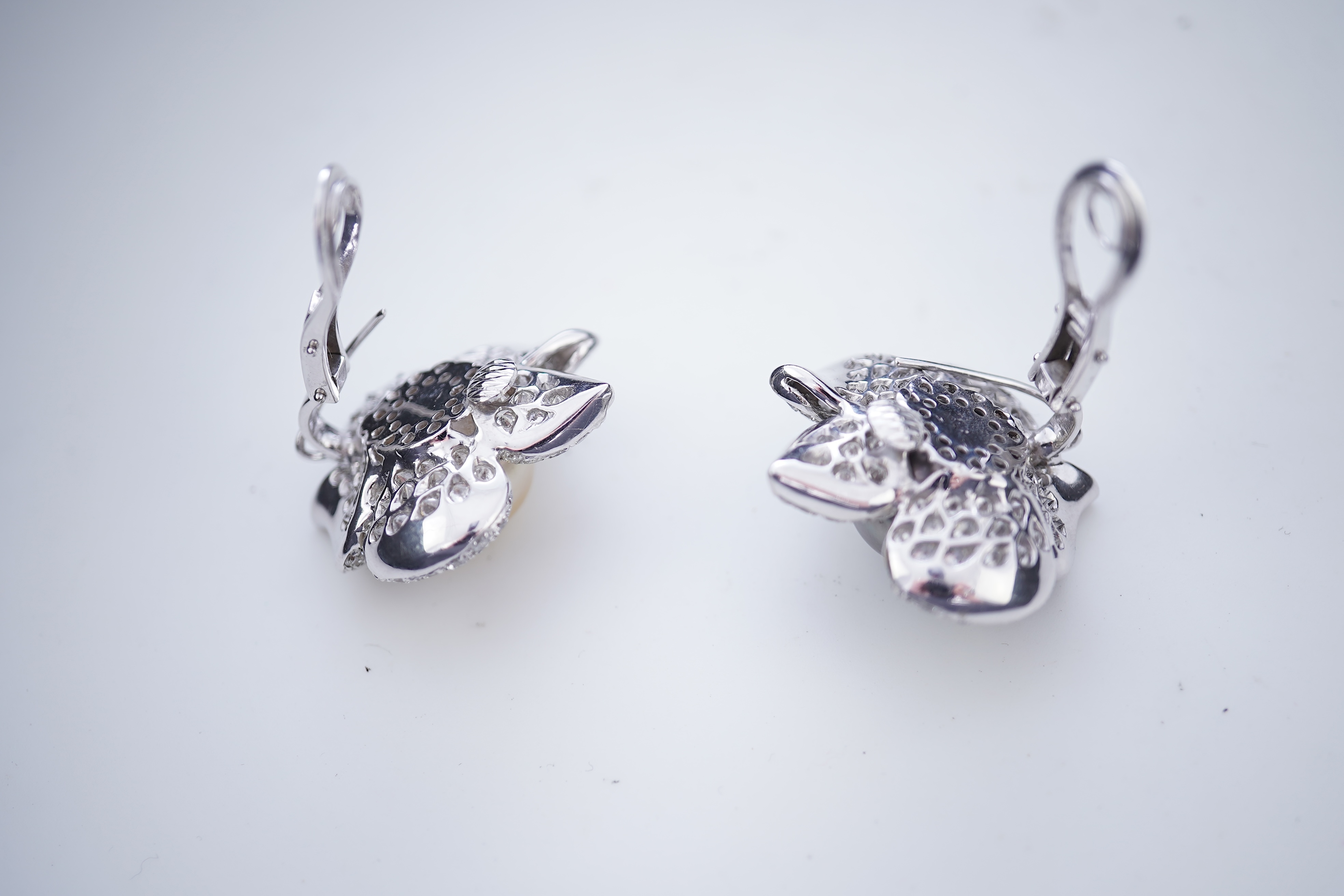 A pair of cultured pearl and diamond ear clips